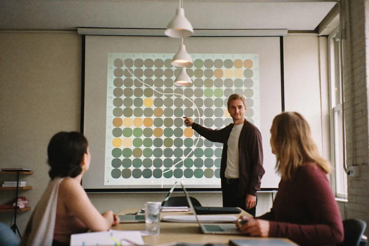 A small agency team going over a client's ranking map on a big screen
